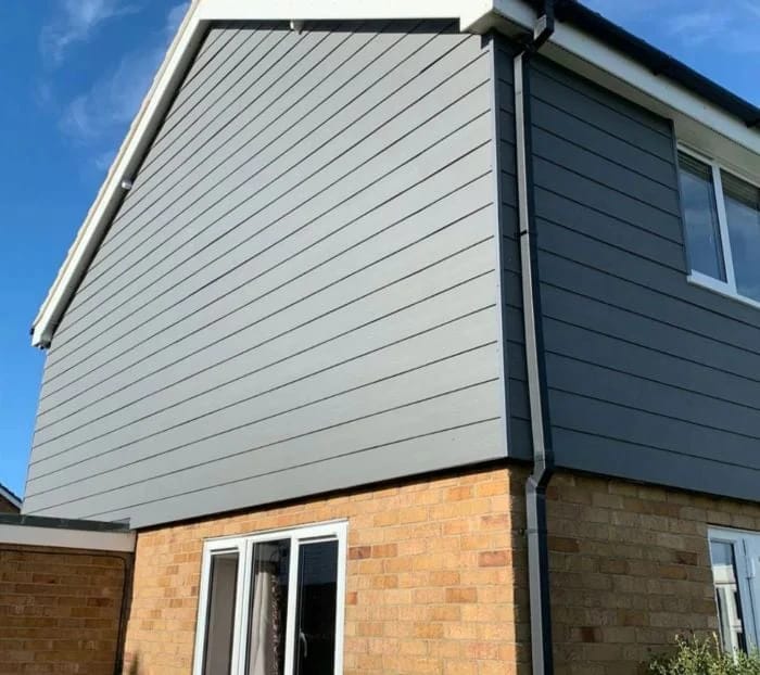 Low-maintenance grey composite cladding on a house in Clacton