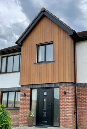 Timber-effect composite cladding on the front of a house