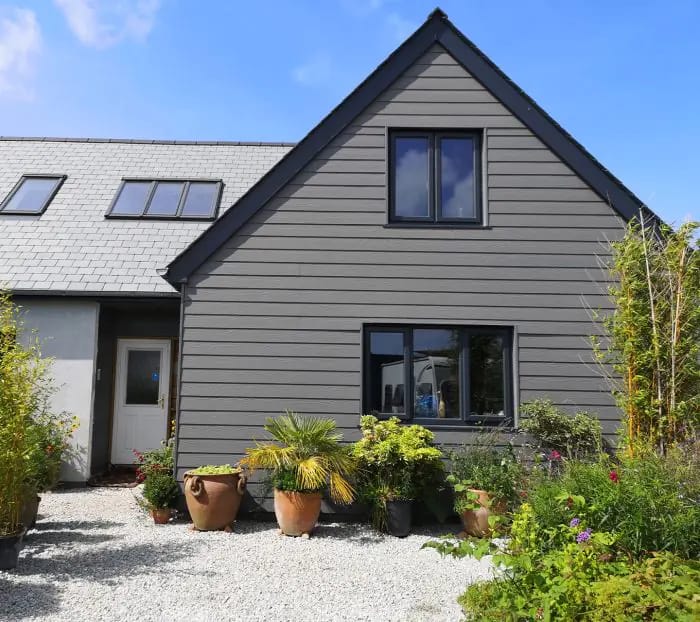 Grey fibre cement cladding on a gable-fronted house