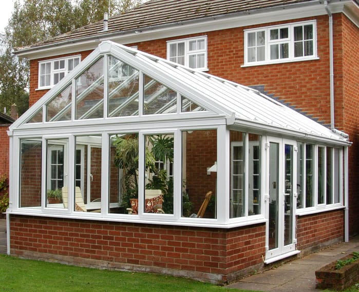 White uPVC gable-fronted conservatory on a brick house