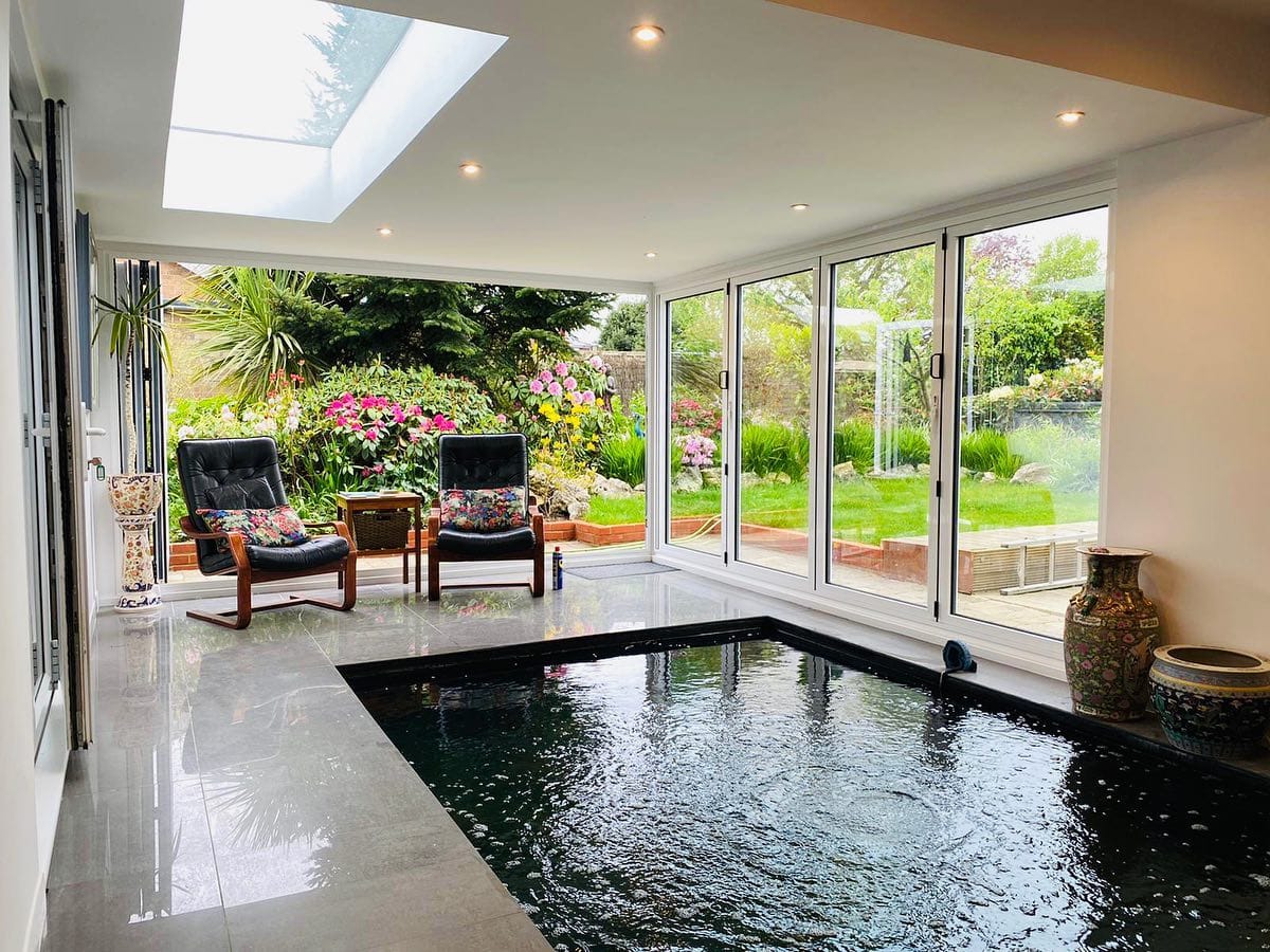 Orangery interior with roof lantern, glazed walls and an indoor pool