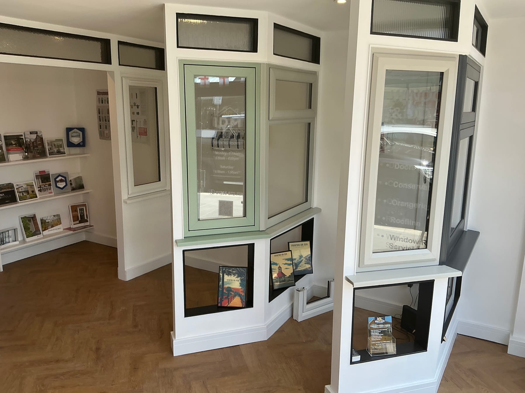 Window displays in sage green and white in the IDM showroom