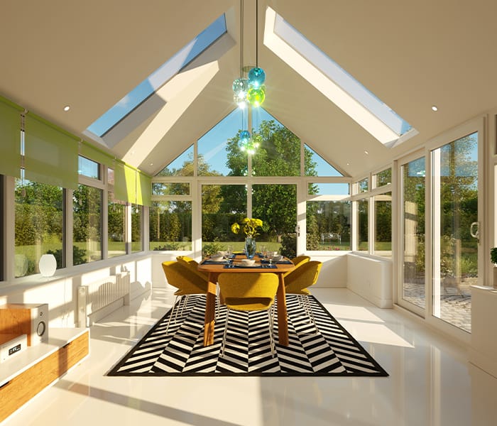 Solid-roof conservatory interior with a vaulted plastered ceiling and glazed gable