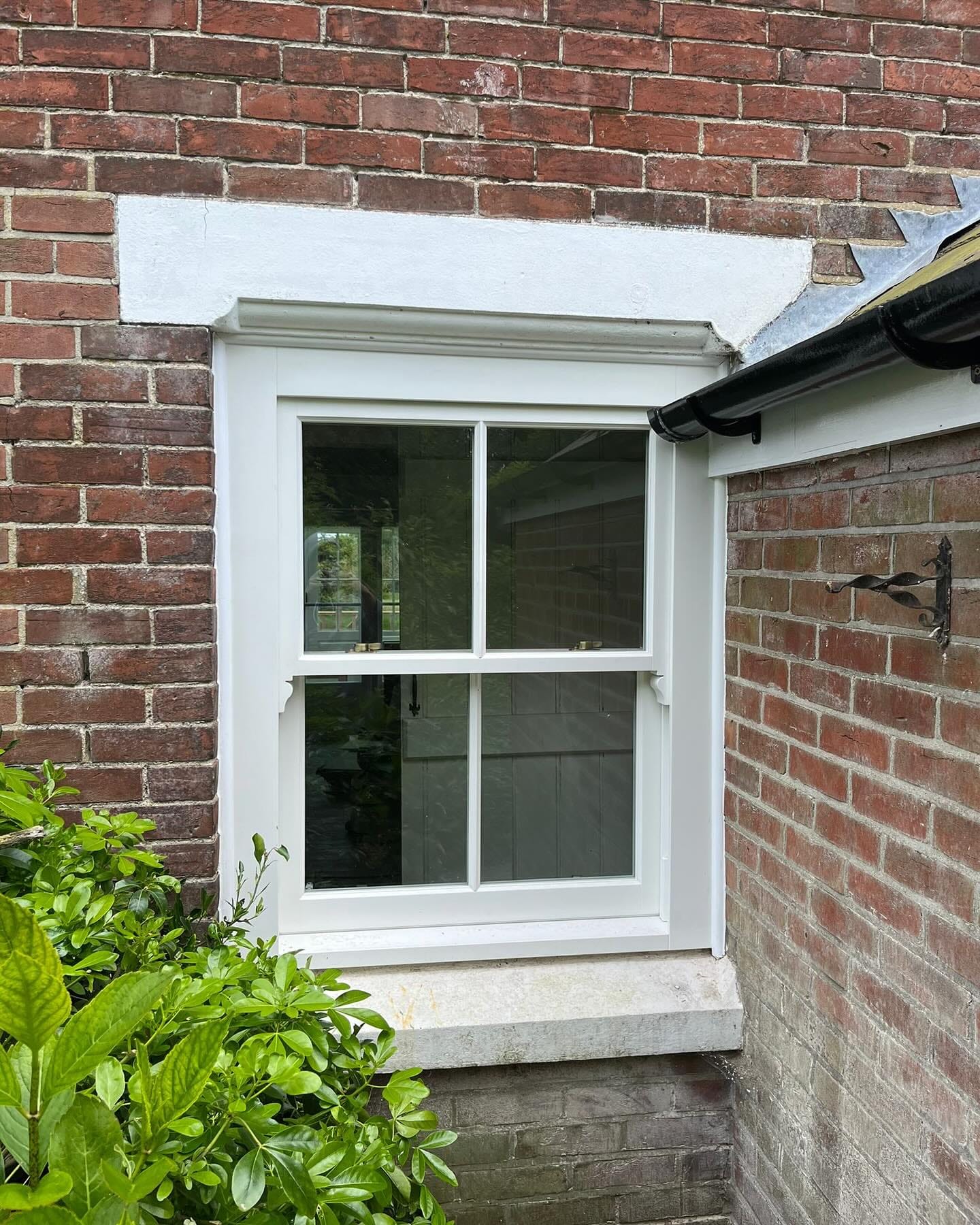 Traditional timber sash window on a brick cottage