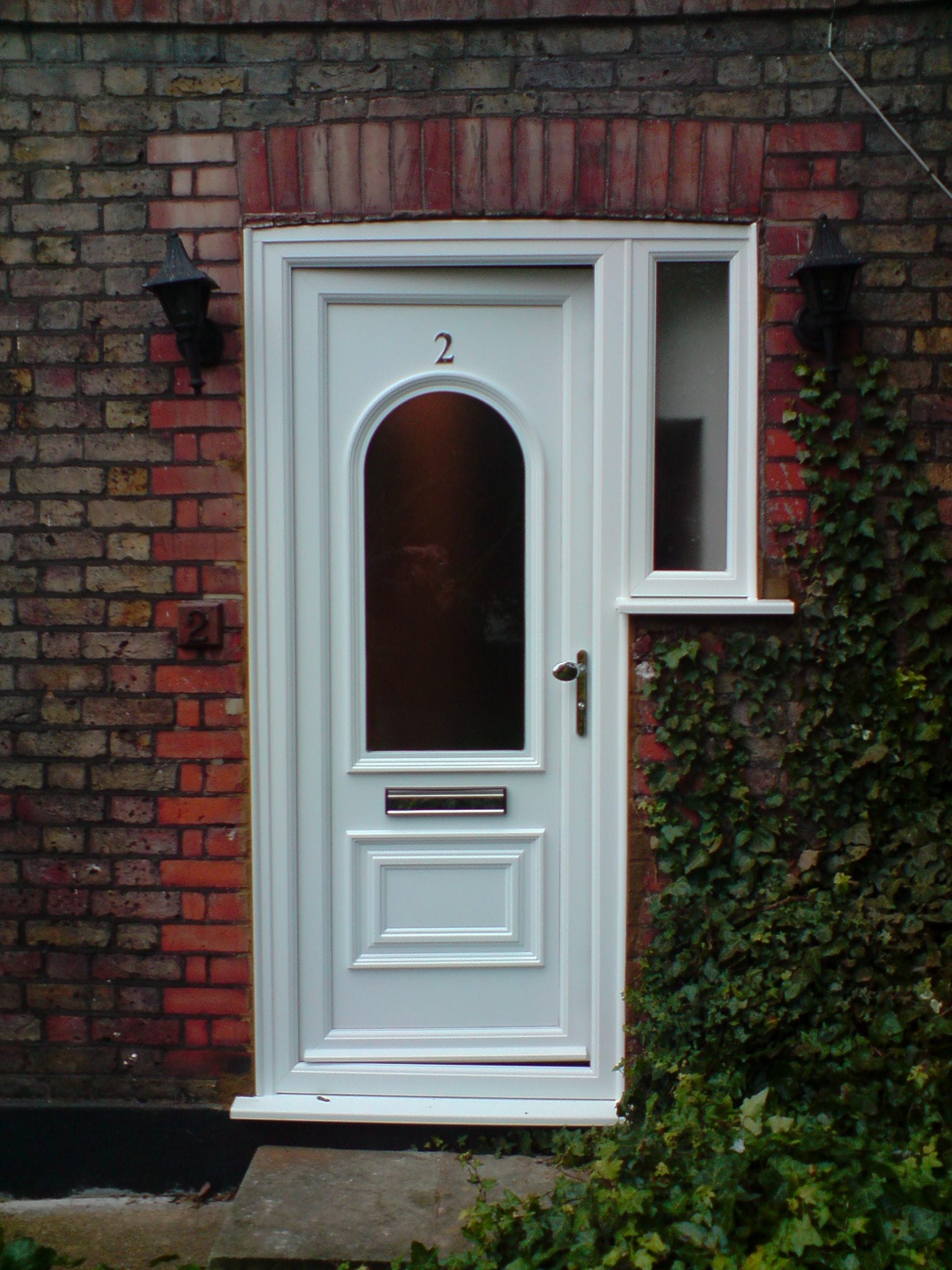 White uPVC front door on a brick house