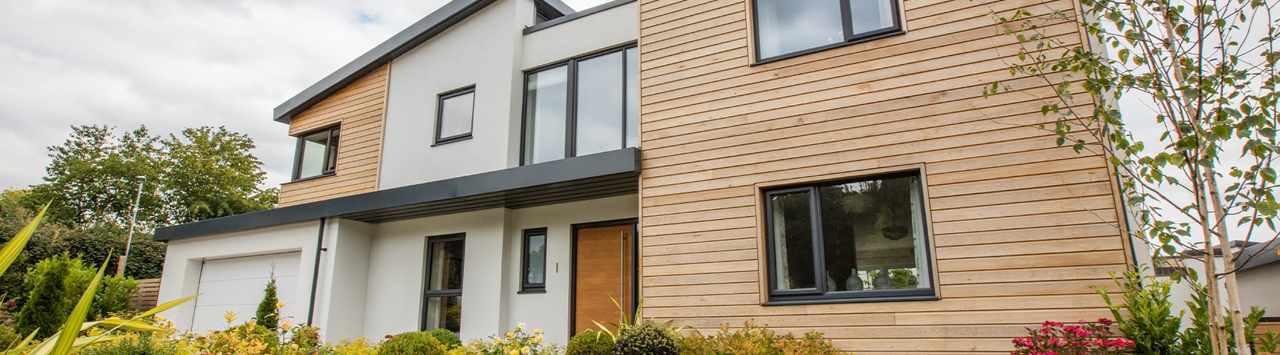 Modern house with anthracite uPVC windows and timber-effect cladding